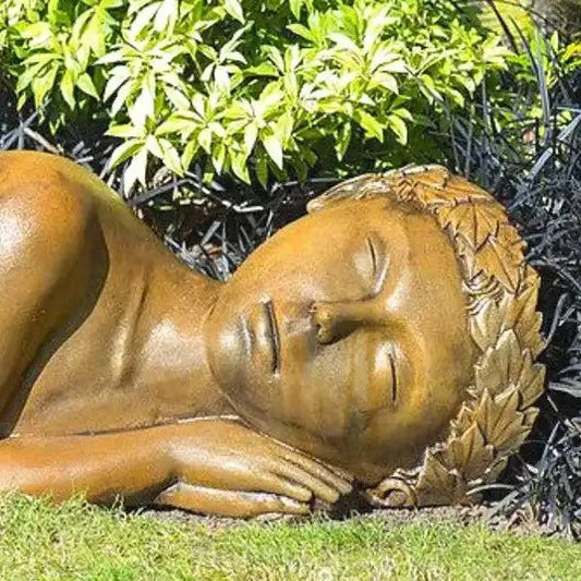 Earth Goddess statue enhancing garden with elegant natural sculpture