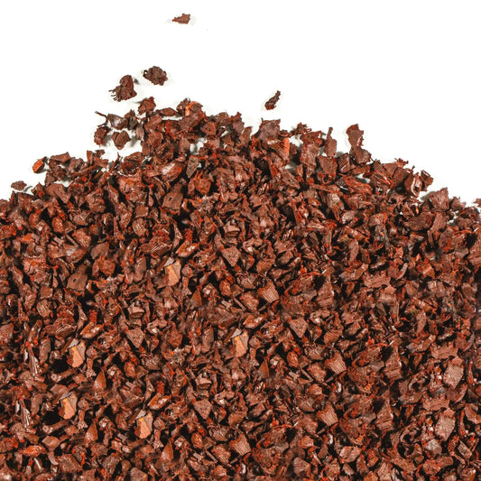 Close-up of vibrant red rubber mulch made from recycled rubber for eco-friendly landscaping and playground safety