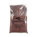 Close-up of Rustic Red Pine Mulch showing uniform texture and rich red color for garden beds and pathways.