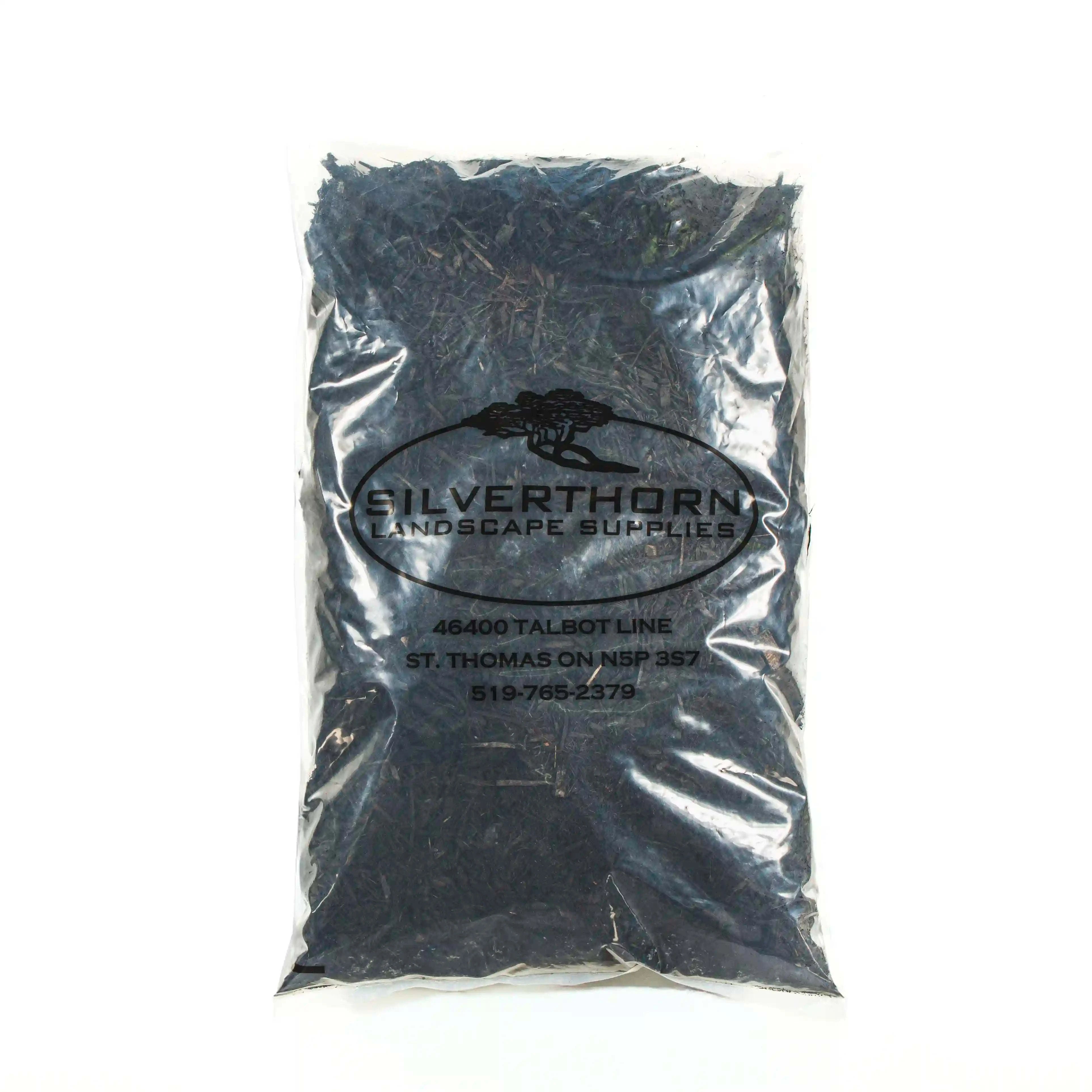 Close-up of rich black mulch with fibrous texture enhancing garden soil and suppressing weeds