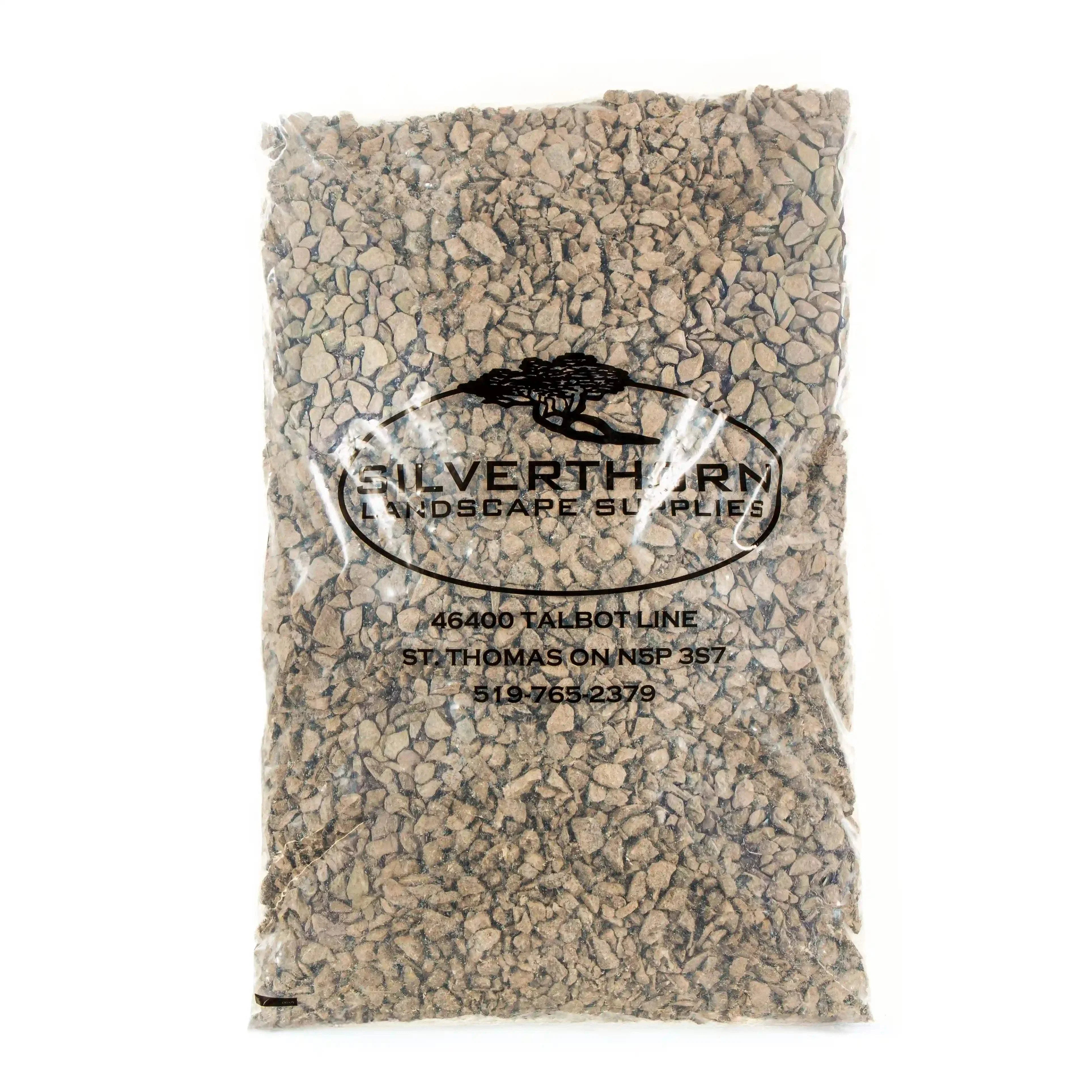 Close-up of clean, angular 5/8" crushed limestone driveway stone for durable, low-maintenance outdoor surfaces and improved drainage