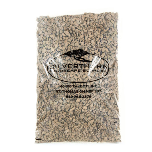 Close-up of clean, angular 5/8" crushed limestone driveway stone for durable, low-maintenance outdoor surfaces and improved drainage