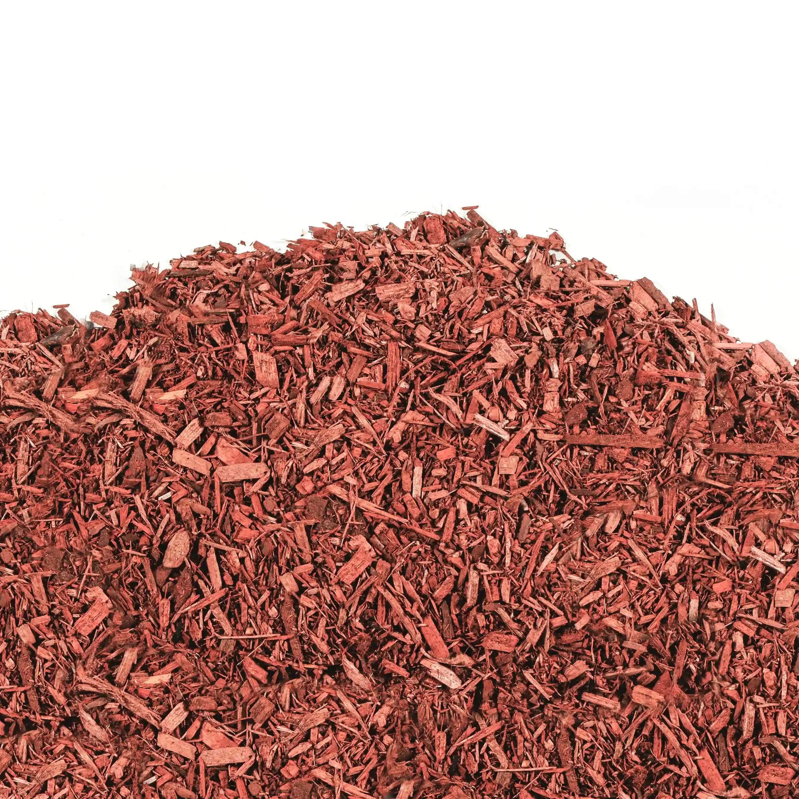Red mulch made from vibrant Ontario pine wood for garden beds and pathways, retaining moisture and suppressing weeds.