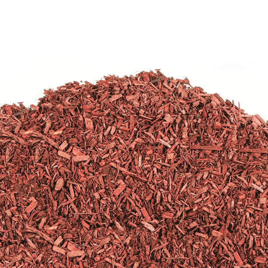 Red mulch made from vibrant Ontario pine wood for garden beds and pathways, retaining moisture and suppressing weeds.